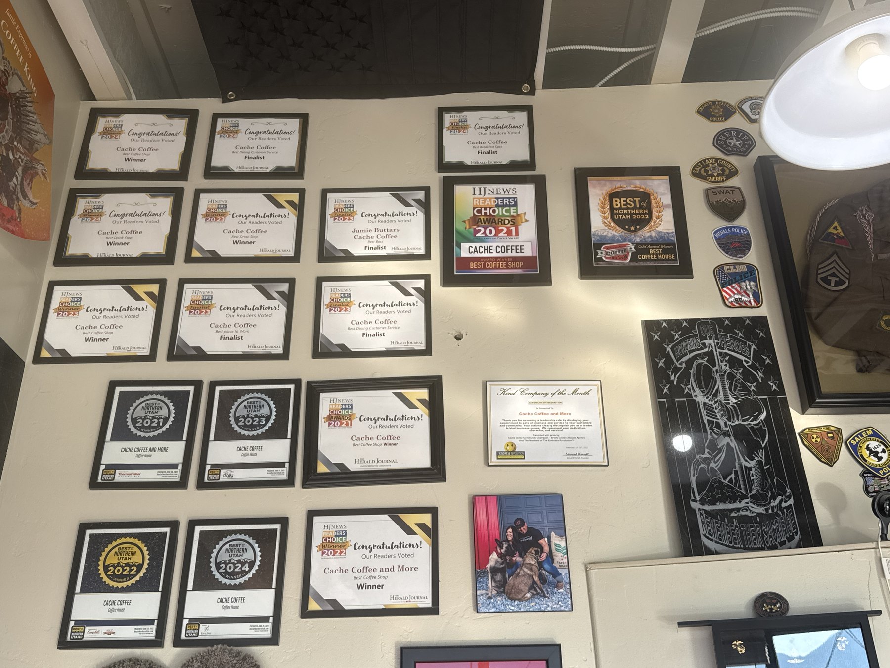 Awards wall at Cache Coffee and More featuring Herald Journal Readers' Choice, Best of Northern Utah, and community recognition plaques