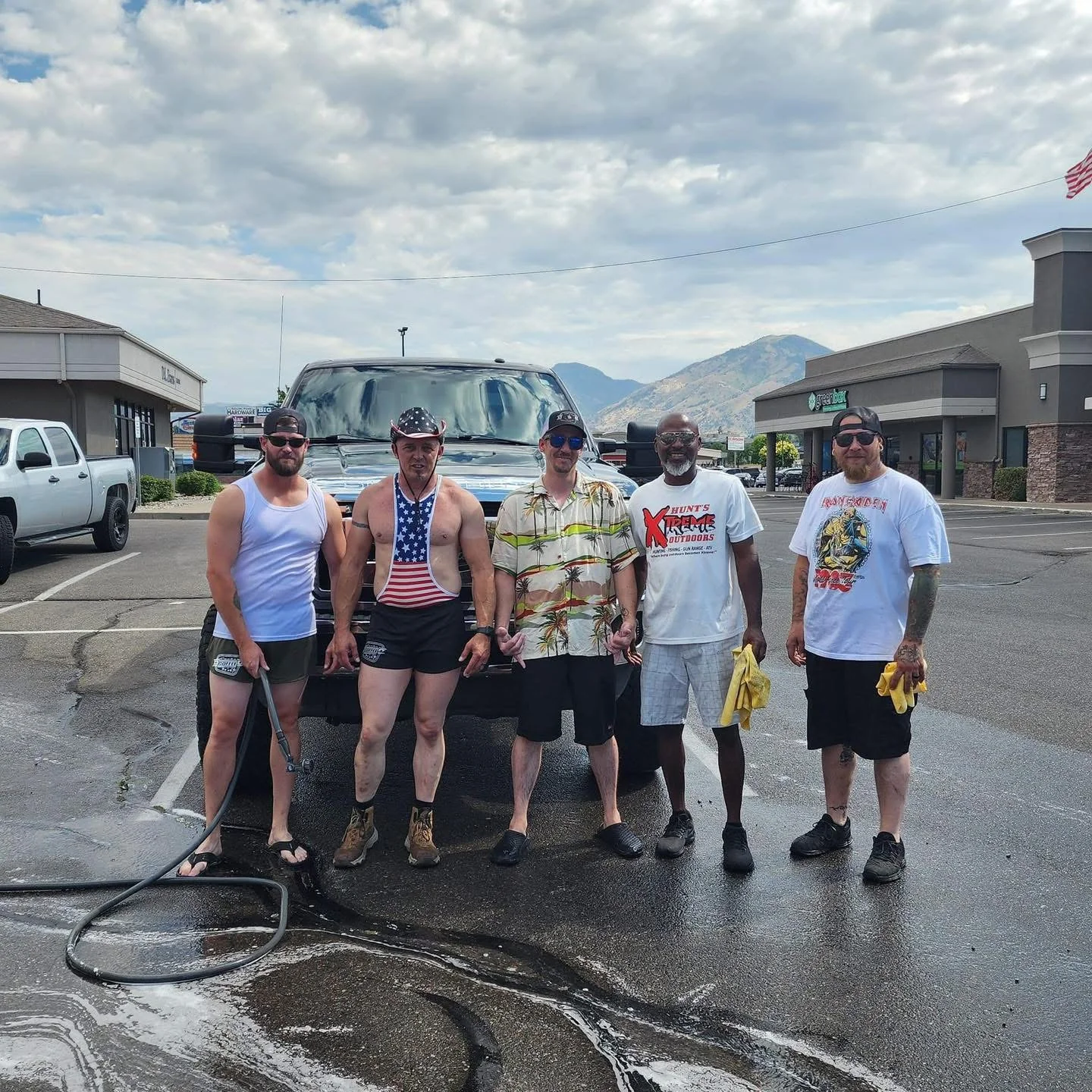 Participants at the annual Hot Rod Dad Bod Car Wash fundraiser for Cache Coffee's Community Safe Storage Program